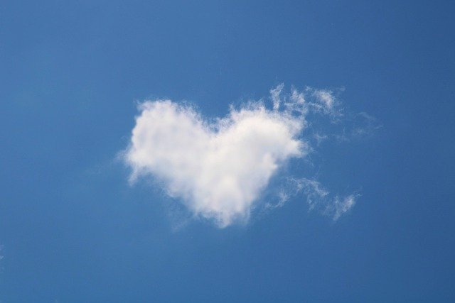 Nature poem for kids - I’m glad the sky is painted blue - heart shaped cloud against a blue sky