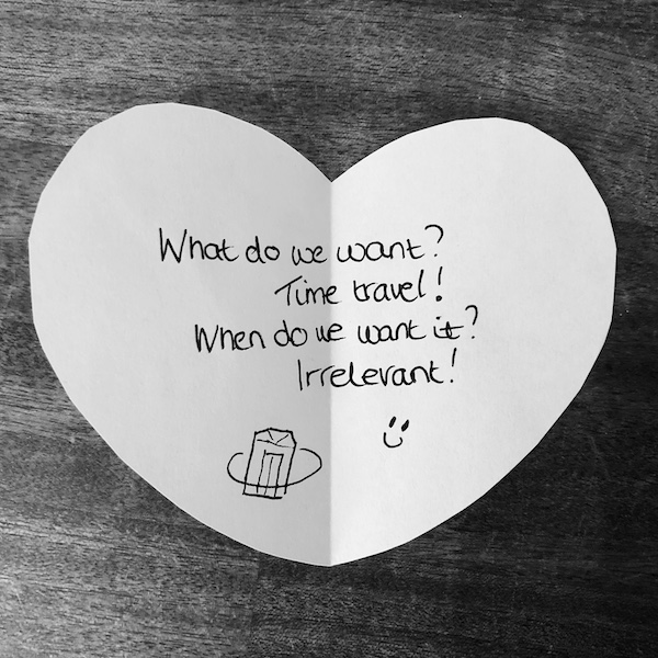 Science joke for kids on a white paper heart: What do we want? Time travel! When do we want it? Irrelevant!