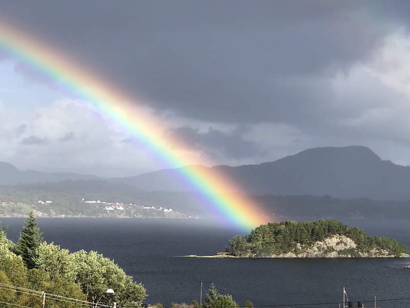 Rainbow over an island in a fjord in Norway