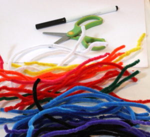 Multi coloured pipe cleaners, scissors, pen and paper