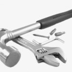 Tools including hammer, spanner, allen key on a white background