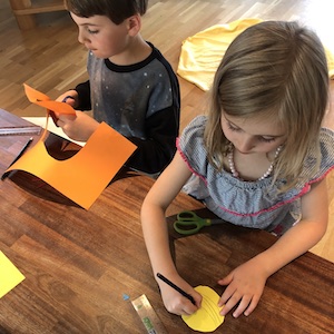 Two children making a scale model of the Solar System